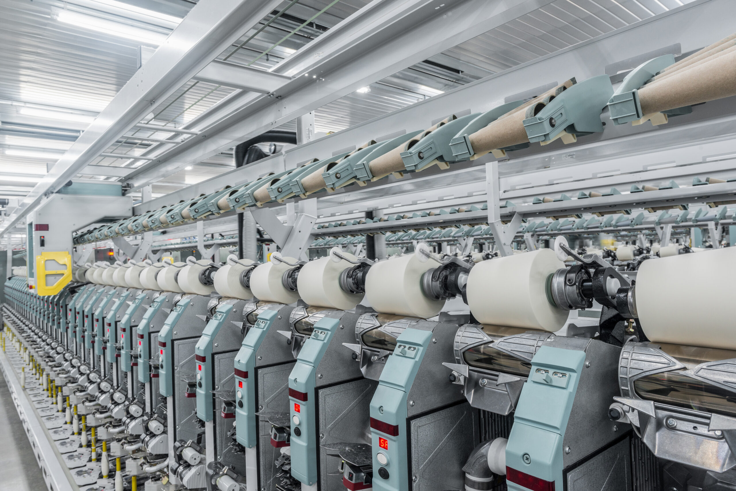 Machinery and equipment in the workshop for the production of thread. interior of industrial textile factory